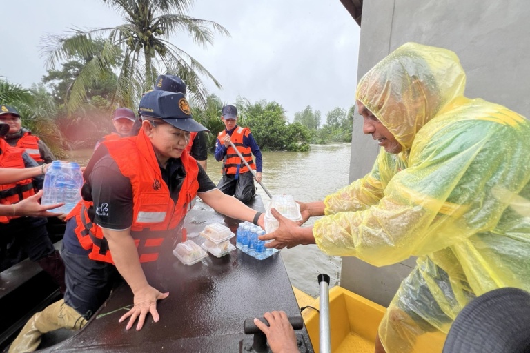 รูปภาพ เจ้าหน้าที่มอบข้าวกล่องและน้ำดื่มให้กับผู้ประสบภัย